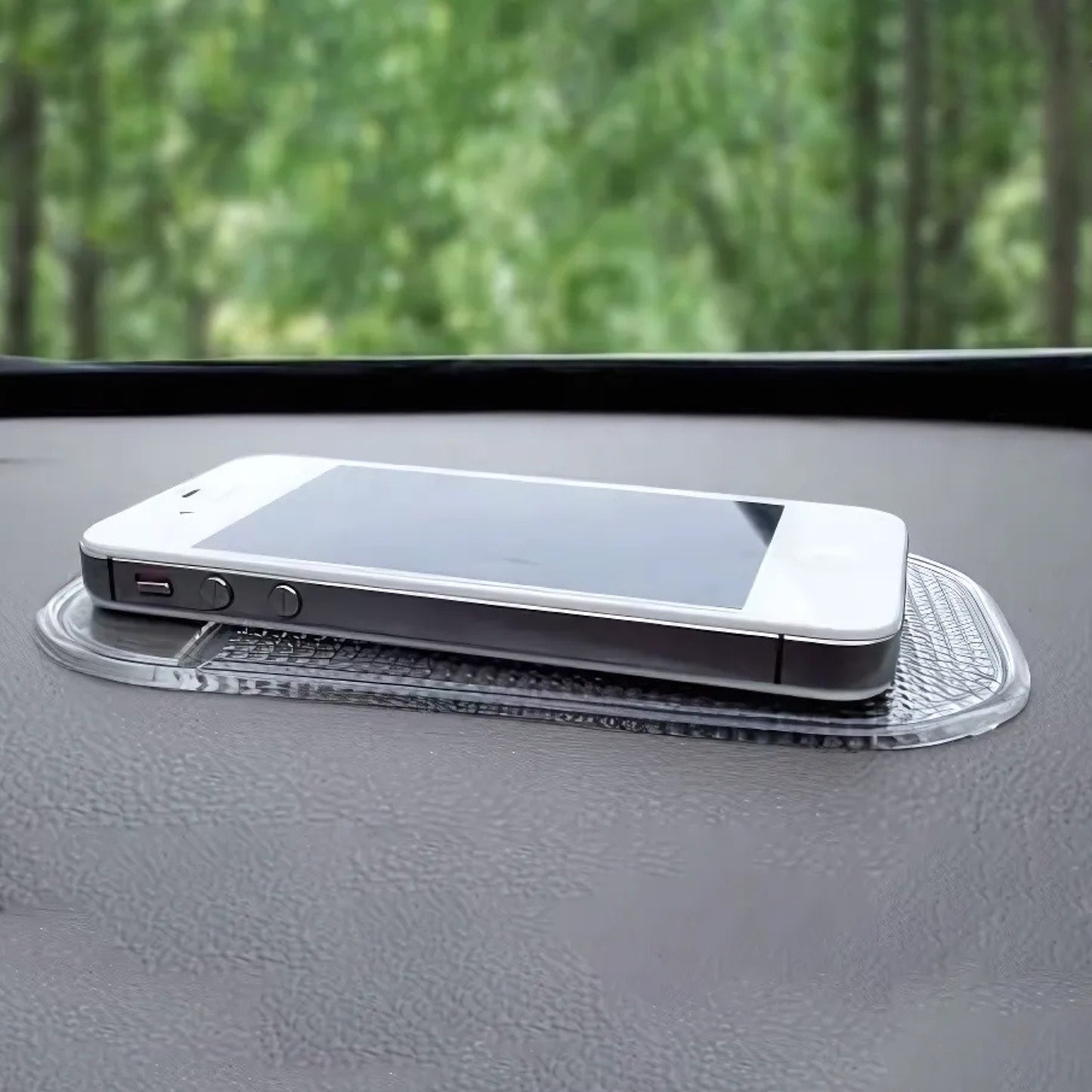 Medium transparent Wukusy automotive anti-slip car dashboard mat displayed on a car dashboard, providing secure placement for items.