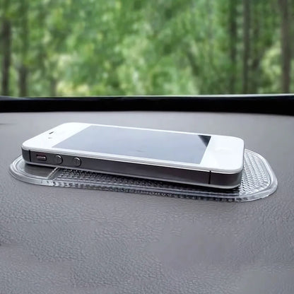 Medium transparent Wukusy automotive anti-slip car dashboard mat displayed on a car dashboard, providing secure placement for items.