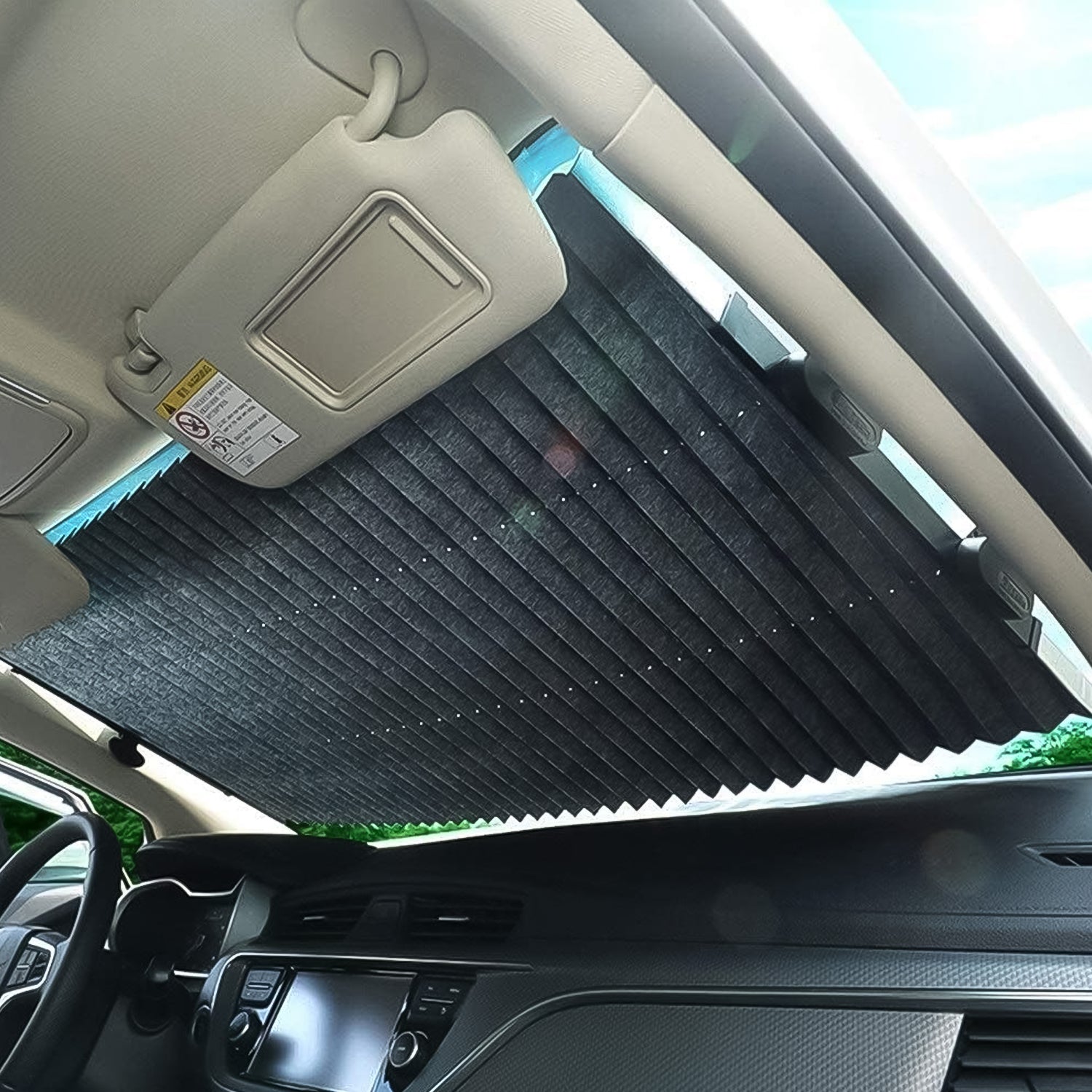Wukusy automotive retractable long foldable windshield sun shade for car, showing the sun shade extended inside a vehicle.
