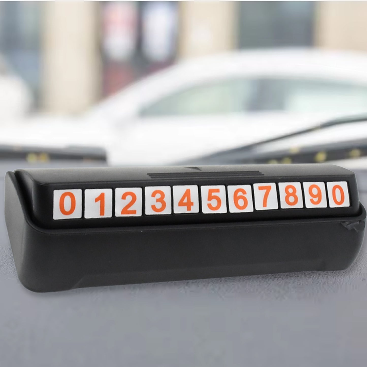 Wukusy automotive temporary car parking mobile number display with magnetic number stickers on a vehicle.