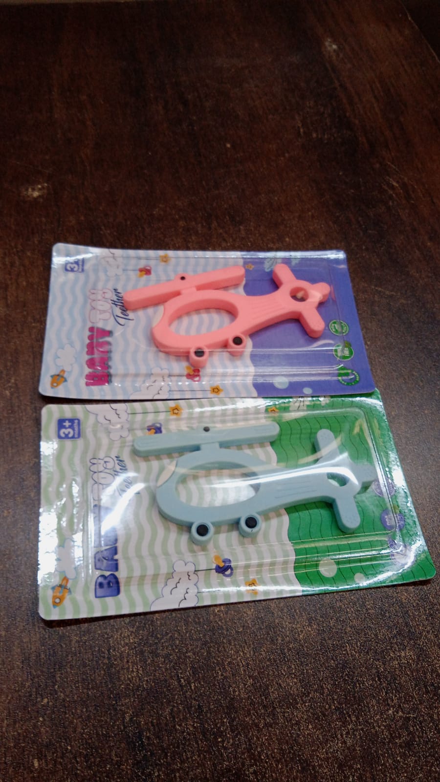 Silicone helicopter-shaped baby teether in mixed colors, designed for infant comfort and teething relief by Wukusy.