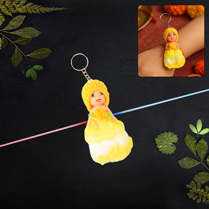Wukusy 2-in-1 kids doll rakhi and keychain bracelet, soft toy design, perfect for Raksha Bandhan, used as bag or key ring accessory.