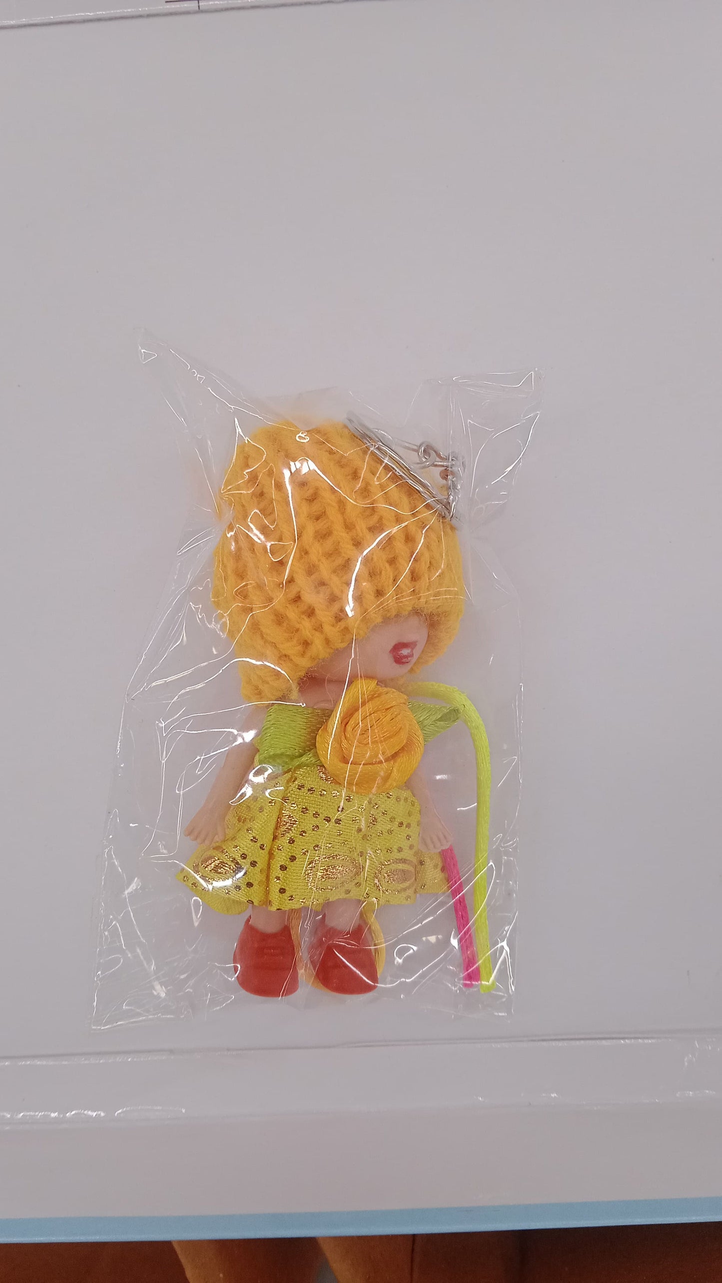 Wukusy 2-in-1 kids doll rakhi and keychain bracelet with soft toy design, suitable for Raksha Bandhan and daily use as bag or key ring.