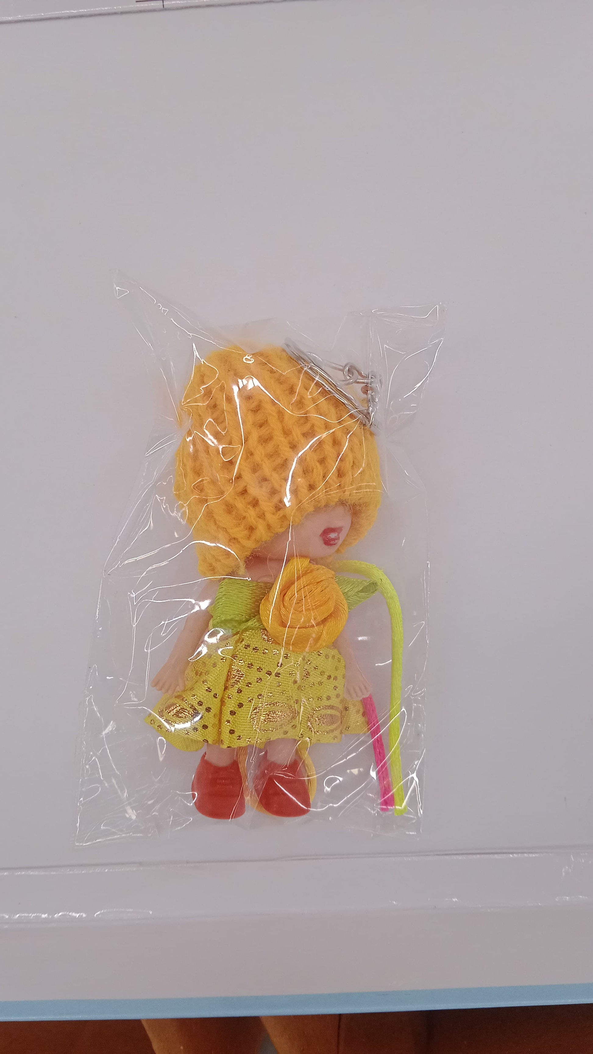 Wukusy 2-in-1 kids doll rakhi and keychain bracelet with soft toy design, suitable for Raksha Bandhan and daily use as bag or key ring.