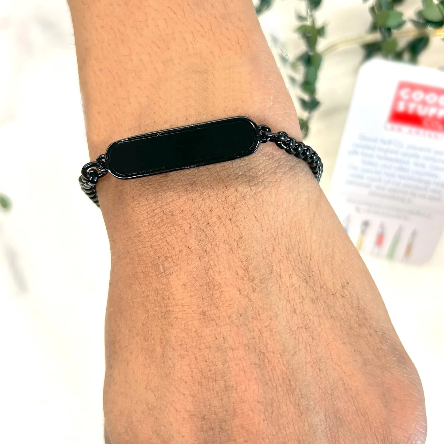 Black Rakhi gift bracelet by Wukusy, stylish bracelet for Raksha Bandhan, featuring a sleek black design on a bracelet.