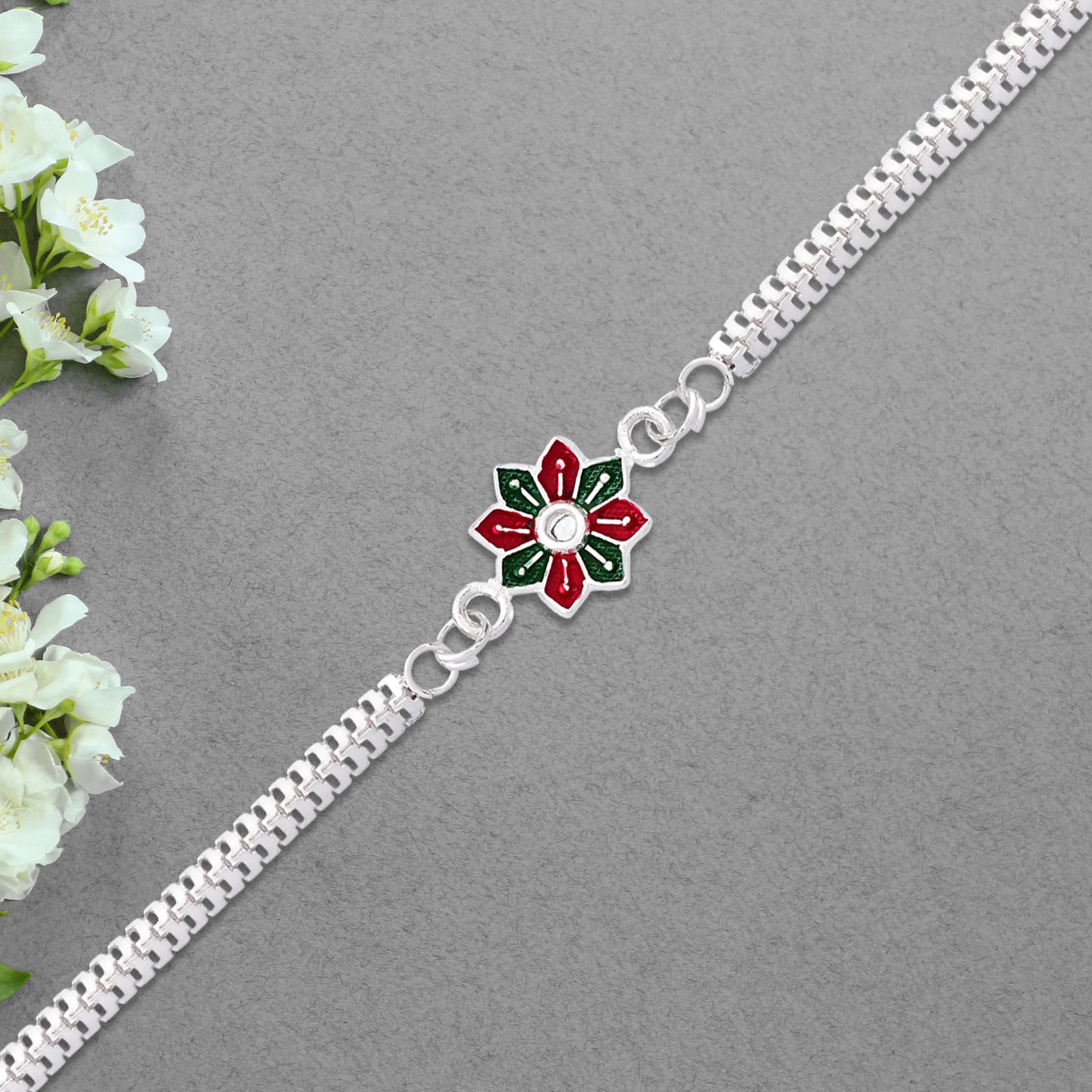 Elegant bracelet-style Rakhi bracelet by Wukusy featuring intricate design and decorative elements on a neutral background.