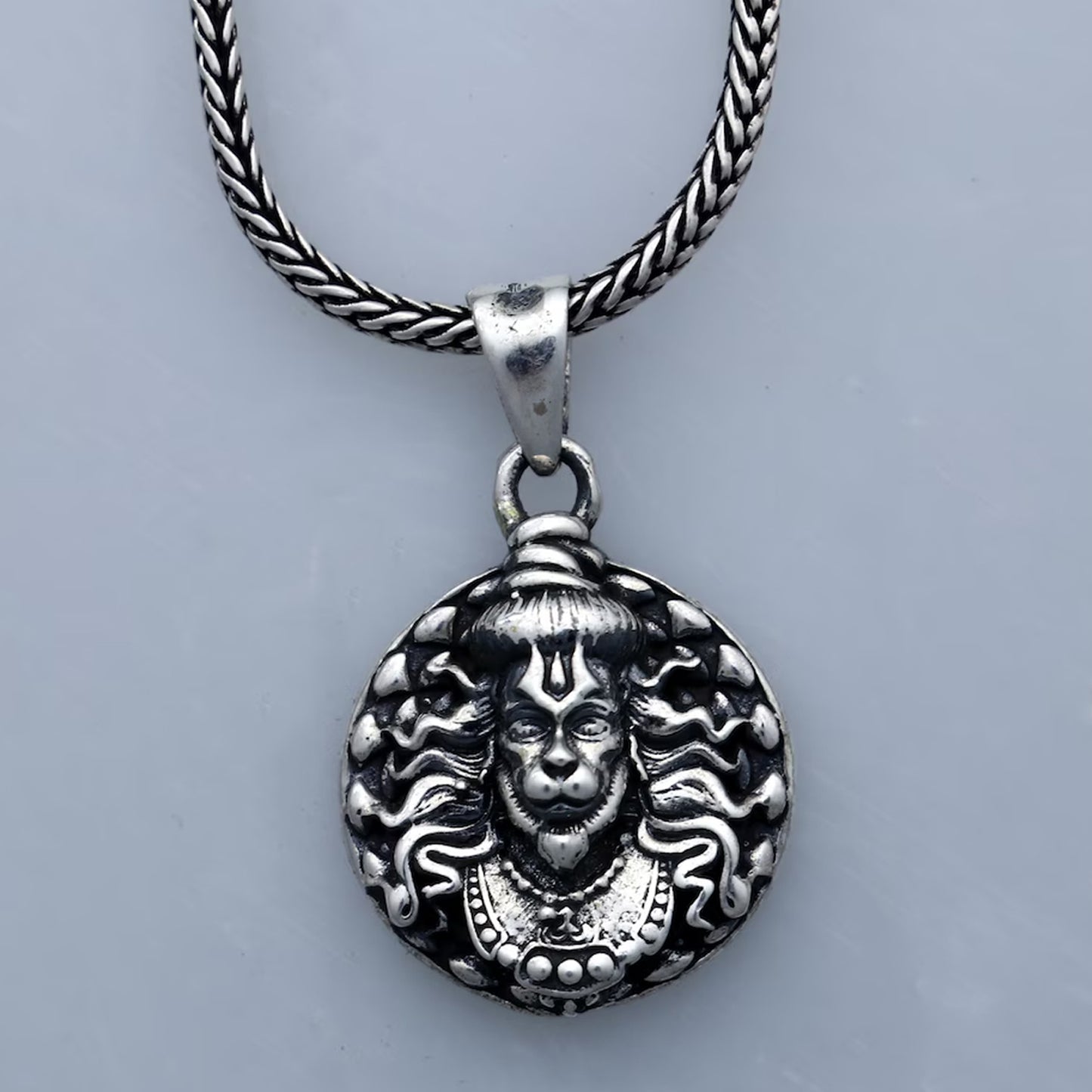 Wukusy Hanuman face pendant bracelet with chain, featuring detailed carved Hanuman face on a durable metal chain.