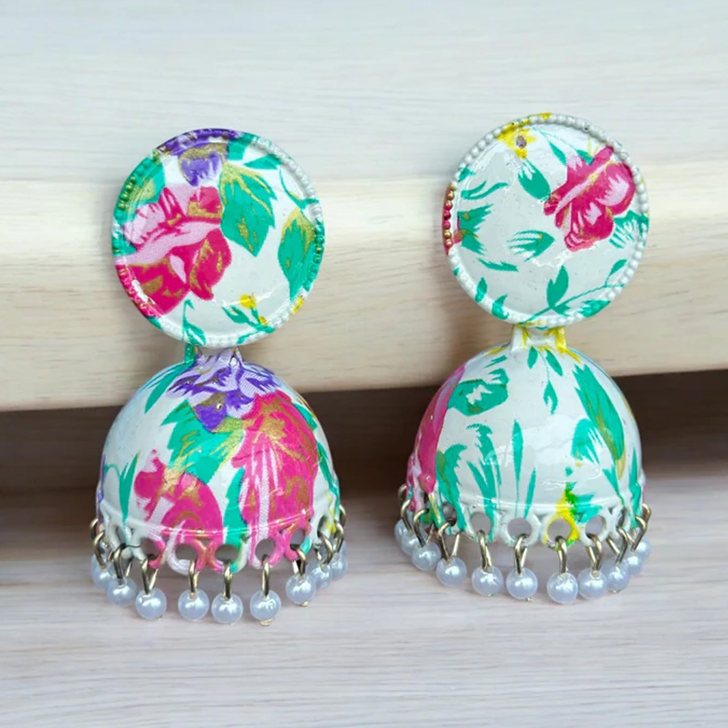 Colorful Wukusy jhumka earrings with traditional buti design, worn by women and girls, showcasing vibrant mixed colors and intricate details.