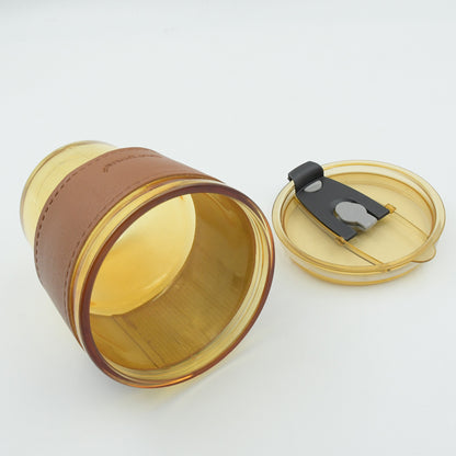 Wukusy glass coffee mug with glass straw, leakproof lid, heatproof sleeve, ideal for travel and hot beverages.