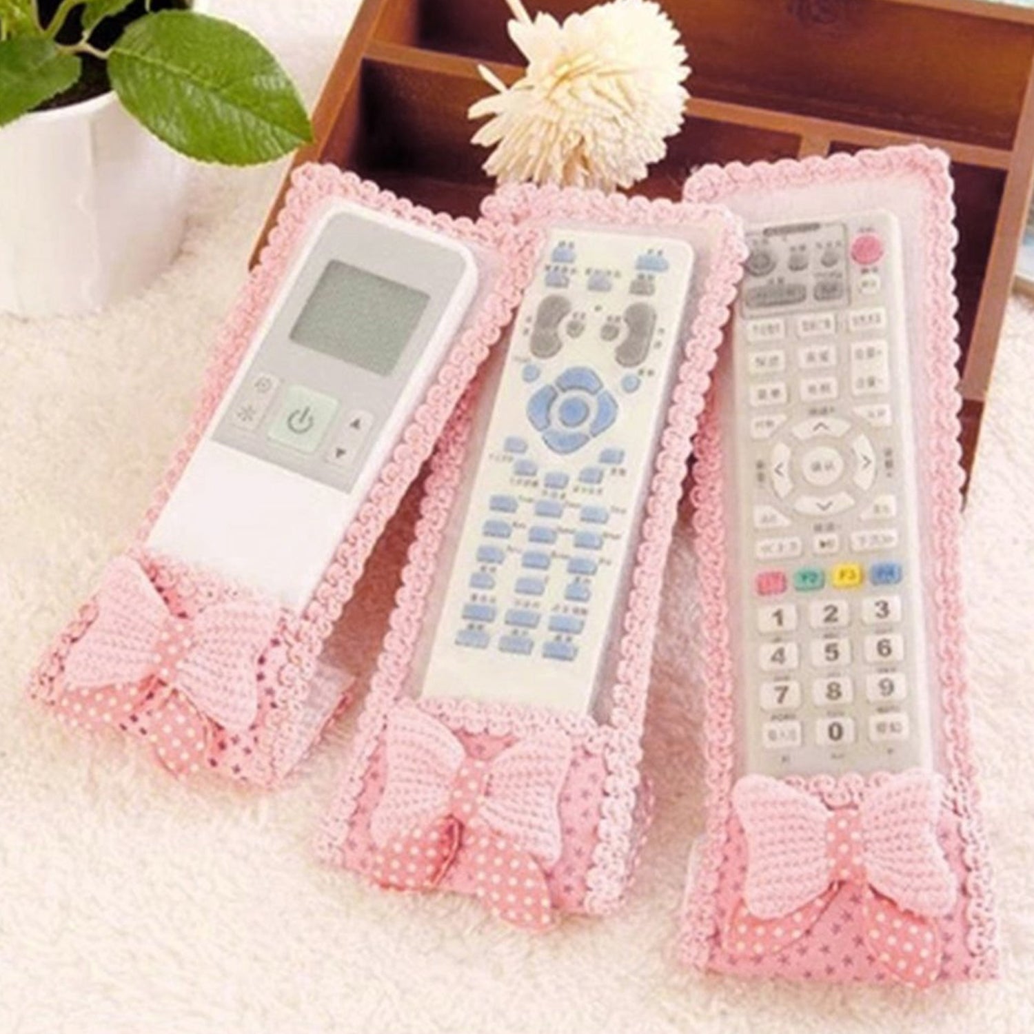 Wukusy 3-piece remote cover set with bow knot for TV and air conditioner remote controls, dust-resistant protective covers.