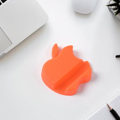 Colorful apple-shaped plastic mobile phone holder by Wukusy, designed to keep your phone steady on a desk.