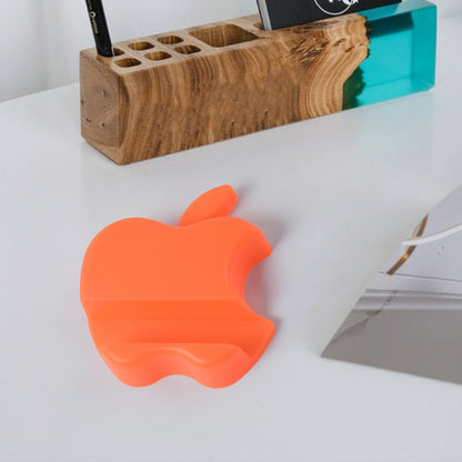 Colorful apple-shaped plastic mobile phone holder by Wukusy, compact desk stand for smartphones in mixed colors.