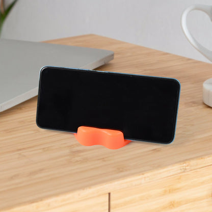 Colorful apple-shaped plastic mobile phone holder by Wukusy, designed to keep your device secure and accessible on a desk.