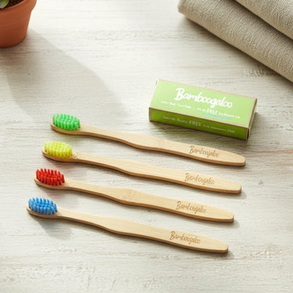 Set of four Wukusy bamboo toothbrushes for adults with eco-friendly handles and soft bristles for gentle brushing.