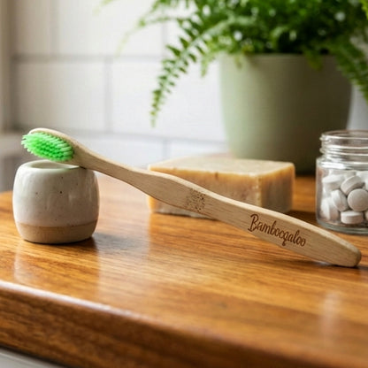 Set of four Wukusy bamboo toothbrushes for adults with eco-friendly bamboo handles and soft bristle heads.