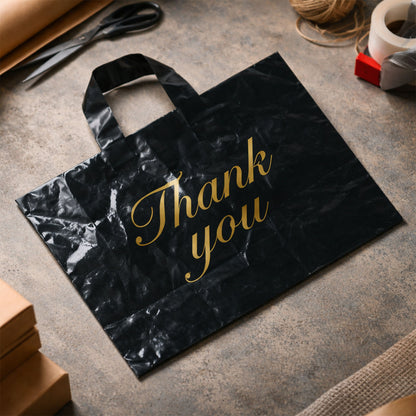 Set of four black Wukusy thank you printed carry bags in mixed sizes, ideal for gift or retail packaging.