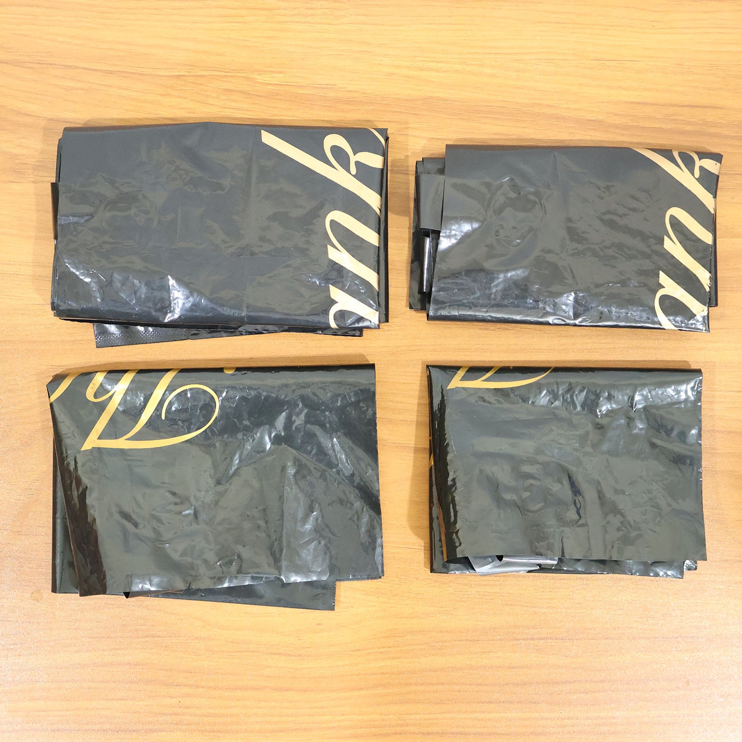 Set of four Wukusy black thank you printed carry bags in mixed sizes for gift packaging and shopping needs.
