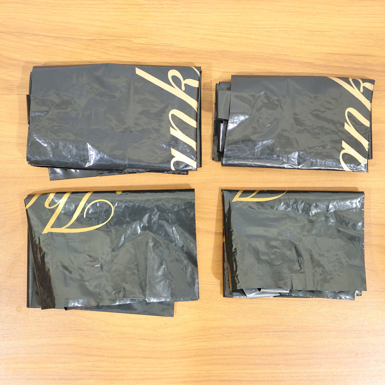 Set of four Wukusy black thank you printed carry bags in mixed sizes for gift packaging and shopping needs.