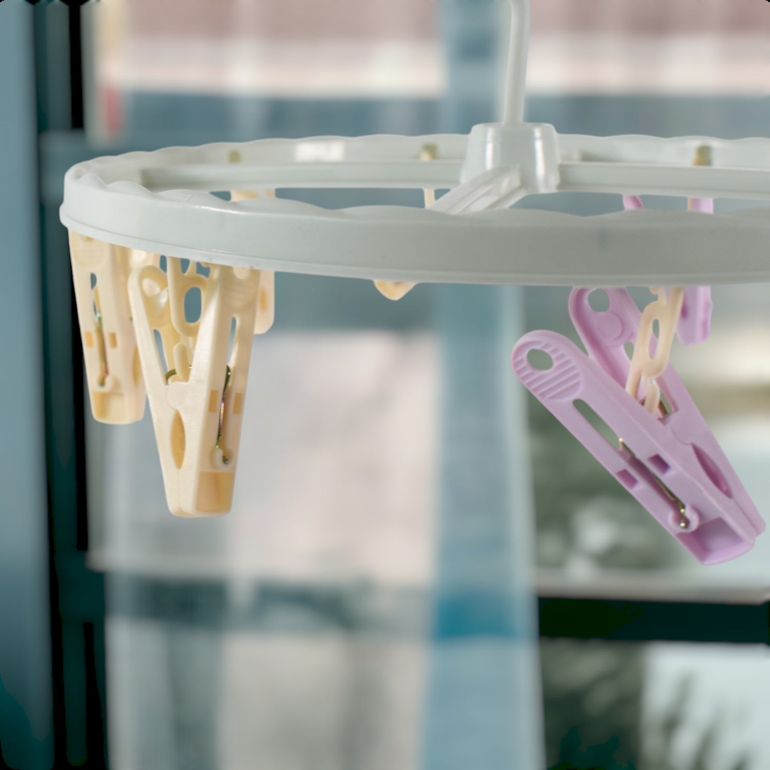 Wukusy clothespin rack laundry drying rack with multiple metal bars for hanging clothes and clothespins.