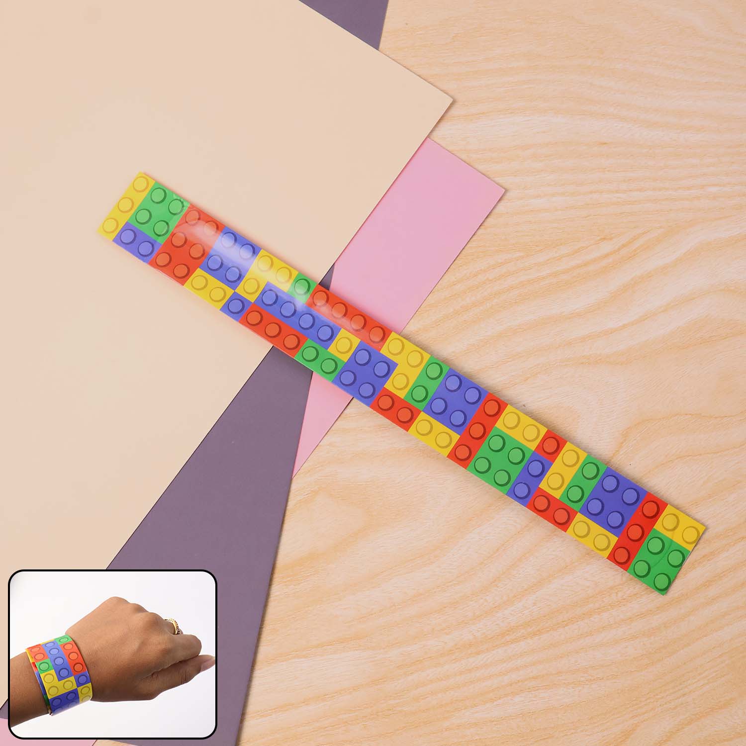 Colorful Snap Slap Bracelet Toy by Wukusy, flexible plastic bracelet with vibrant colors and snap closure, suitable for kids.