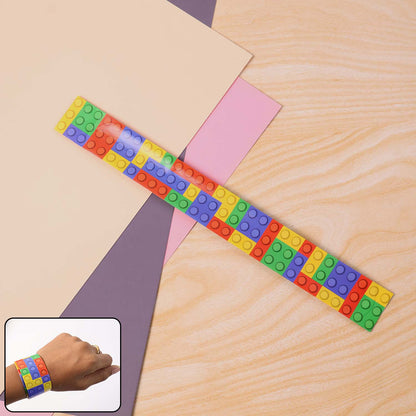 Colorful Snap Slap Bracelet Toy by Wukusy, flexible plastic bracelet with vibrant colors and snap closure, suitable for kids.
