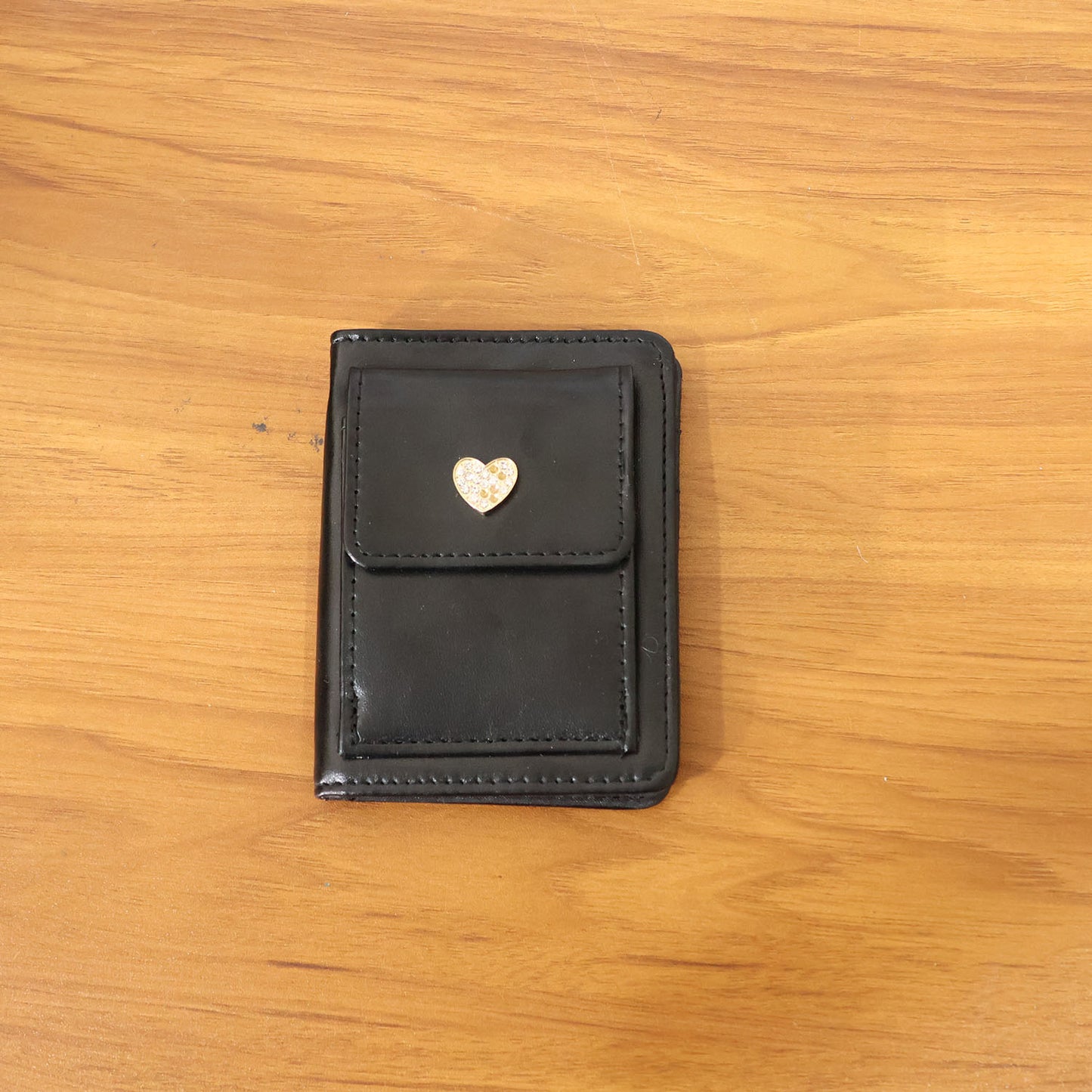 Wukusy compact snap button card holder wallet with multiple card slots, black leather finish, and secure snap closure.