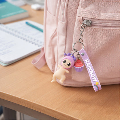 Wukusy cute doll cupcake keychain with rainbow strap, featuring a small, colorful doll and cupcake design on a vibrant strap.