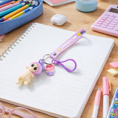 Cute doll cupcake keychain with rainbow strap from Wukusy, featuring a colorful, detailed cupcake design and plush doll charm.