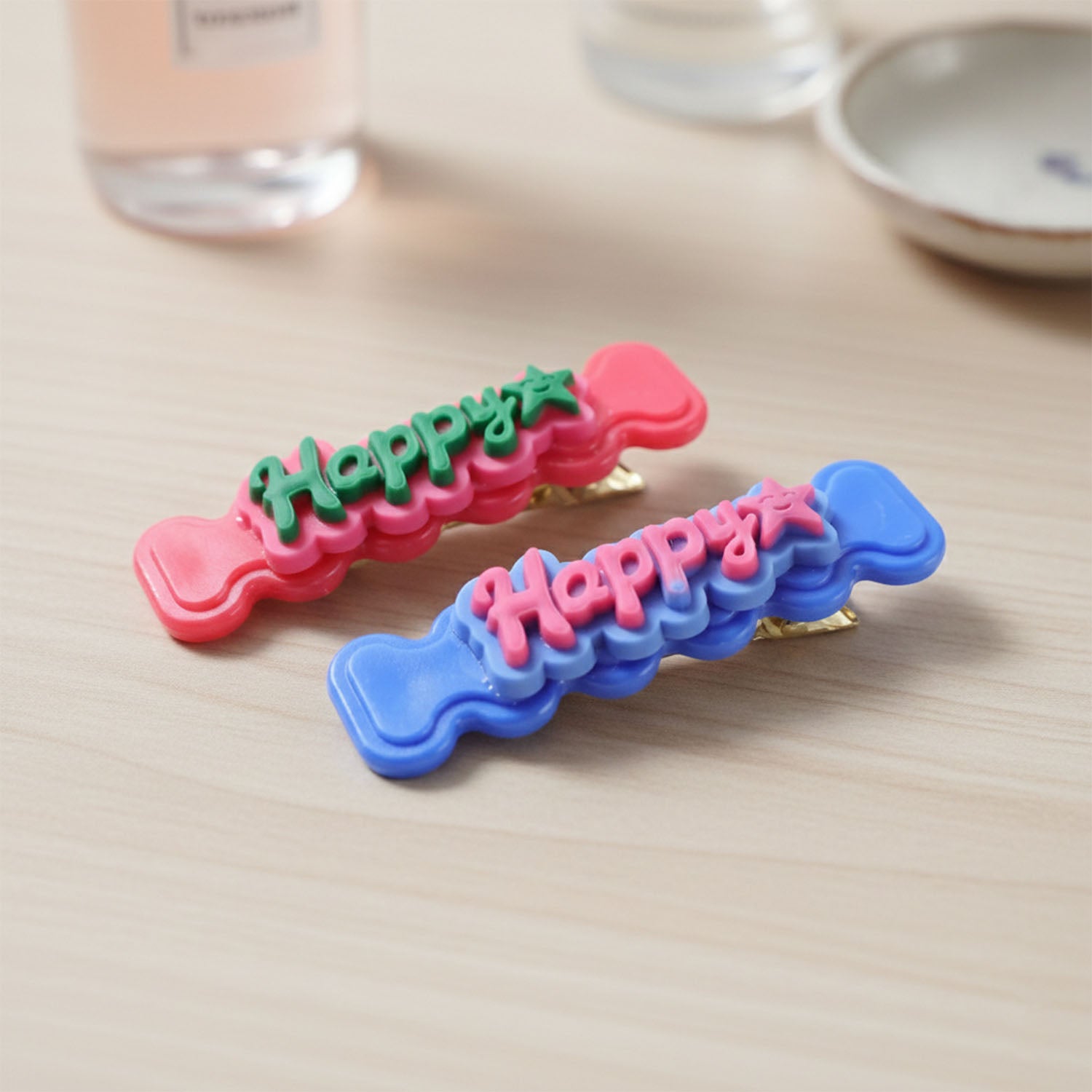 Set of four Wukusy cute bone-shaped snap hair clips with happy facial designs for children’s playful hair accessories.