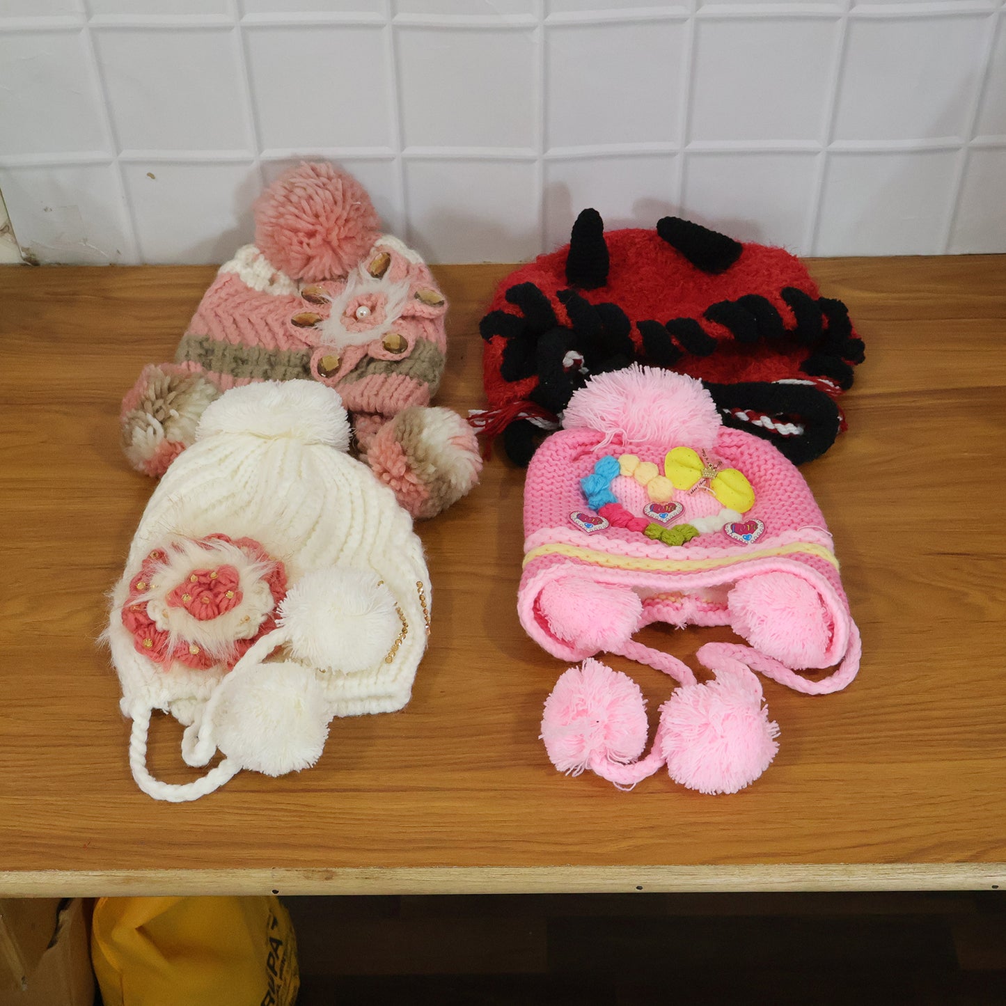 Cute kids winter woolen ear flap cap with pom-pom from Wukusy, featuring mix designs and cozy, warm fleece material