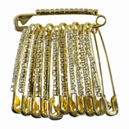 Set of 12 decorative golden safety pin brooches by Wukusy, stylish accessory set with intricate designs on each pin.