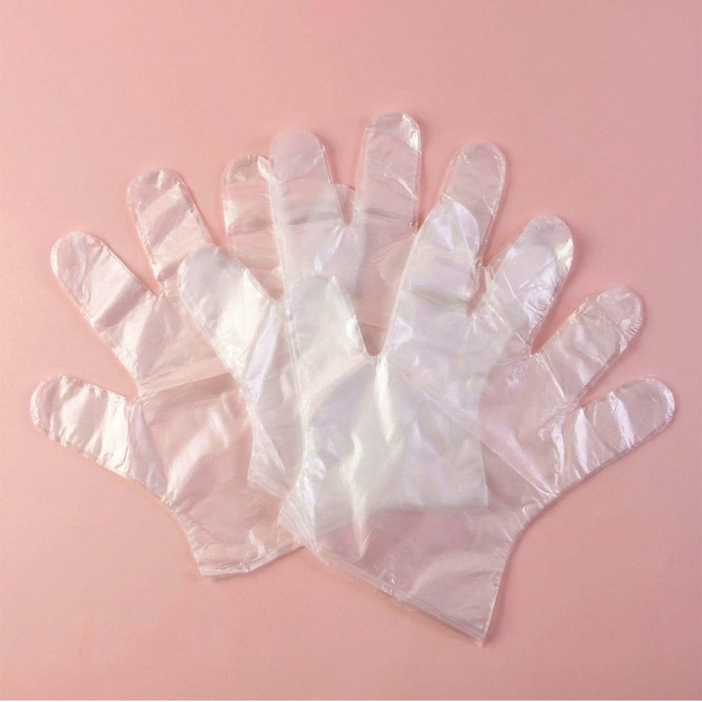 Disposable clear gloves by Wukusy, 50-pack, showing a row of transparent latex gloves for medical, cleaning, or food handling use.