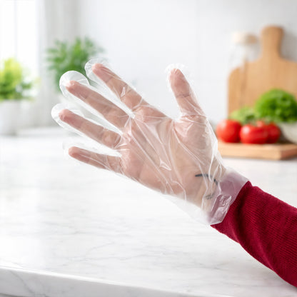 Pair of small-sized disposable plastic hand gloves by Wukusy, 100-pack, showing the lightweight, clear gloves suitable for hygiene tasks.