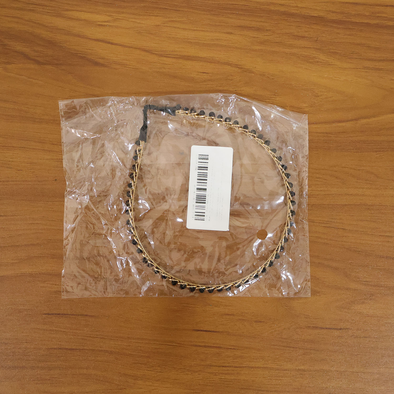 Elegant gold finish decorative hair band by Wukusy, showcasing a stylish and shiny accessory for hair styling.