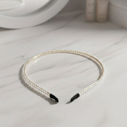 Elegant pearl beaded slim golden metal hair band by Wukusy, featuring delicate pearl accents and a sleek design for stylish hair accessories.