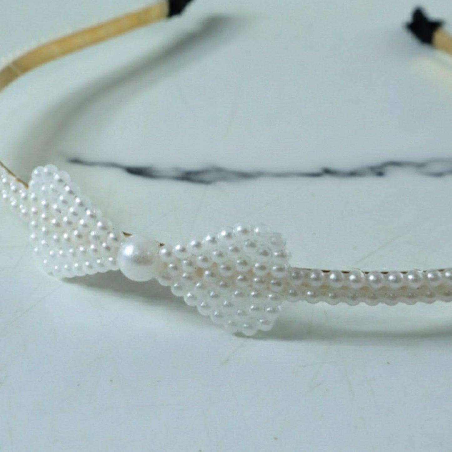 Elegant pearl beaded slim metal hair band by Wukusy featuring delicate pearl detailing on a sleek metal band.