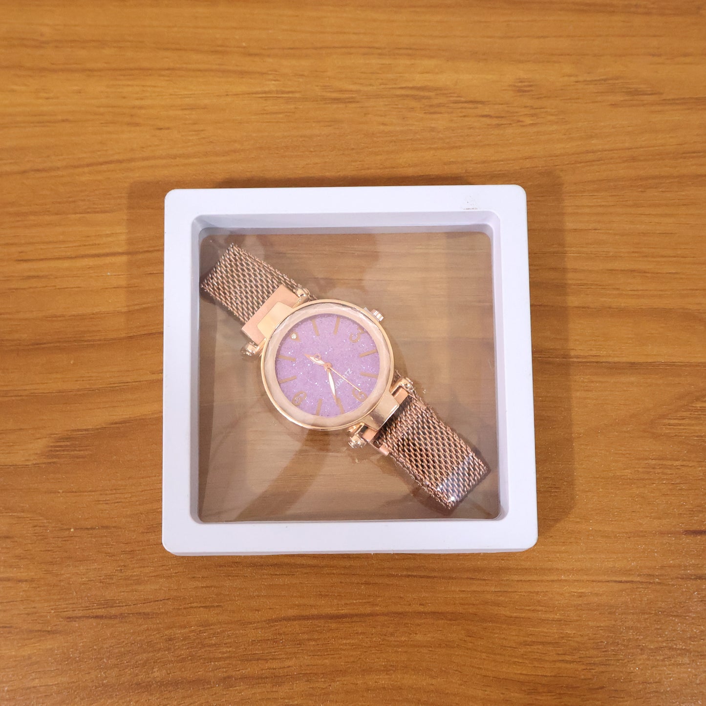 Elegant Wukusy women's analog wrist watch with a sleek design, displayed in a stylish presentation box.