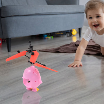 Pink owl-shaped RC flying bird toy with LED lights and remote control by Wukusy, perfect for kids' outdoor play.