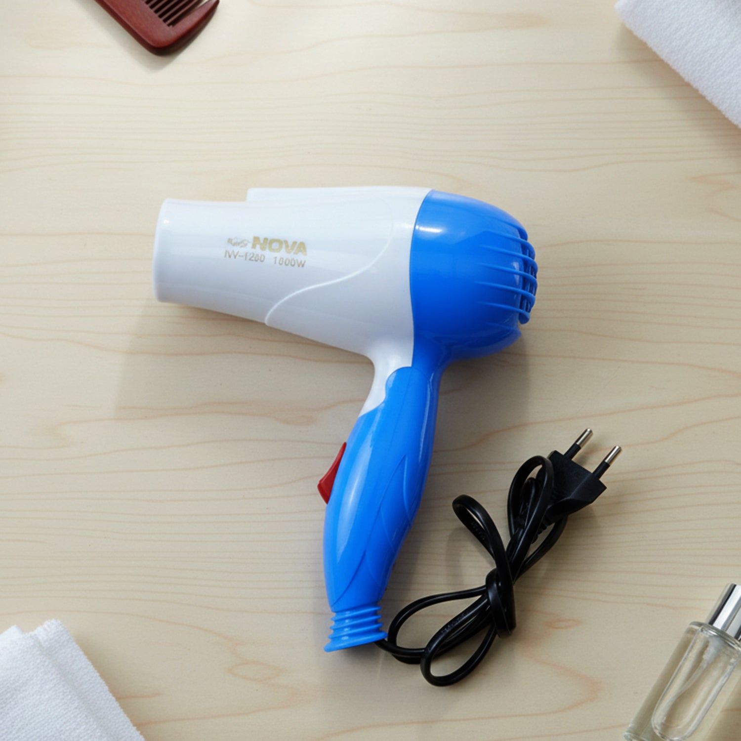 Wukusy foldable hair dryer with dual speed settings, 1000W, compact design, white and black color, suitable for travel and home use.