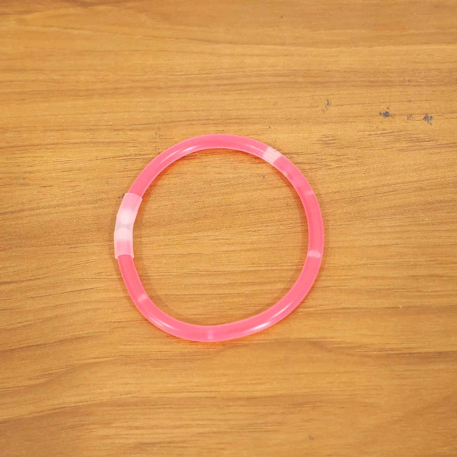 Wukusy glow-in-the-dark light bracelet on a person's wrist, showcasing its luminous design and flexible band.