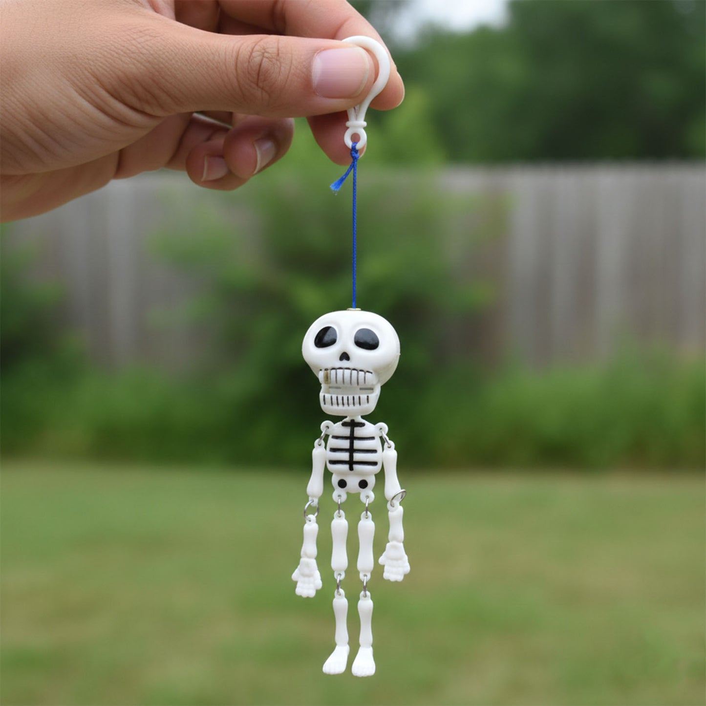 Wukusy hanging skeleton doll keychain with detailed skull and bones, perfect for bags or keys, made of durable material.