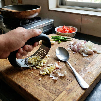 Wukusy heavy-duty garlic press tool with matching spoon set, durable stainless steel kitchen utensils for garlic crushing and prep.