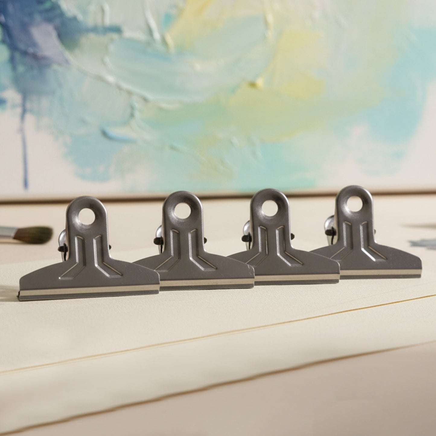 Set of four heavy-duty metal paper clamp clips by Wukusy, ideal for securing documents and crafts with strong grip.