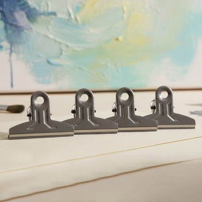 Set of four heavy-duty metal paper clamp clips by Wukusy, ideal for securing documents and crafts with strong grip.