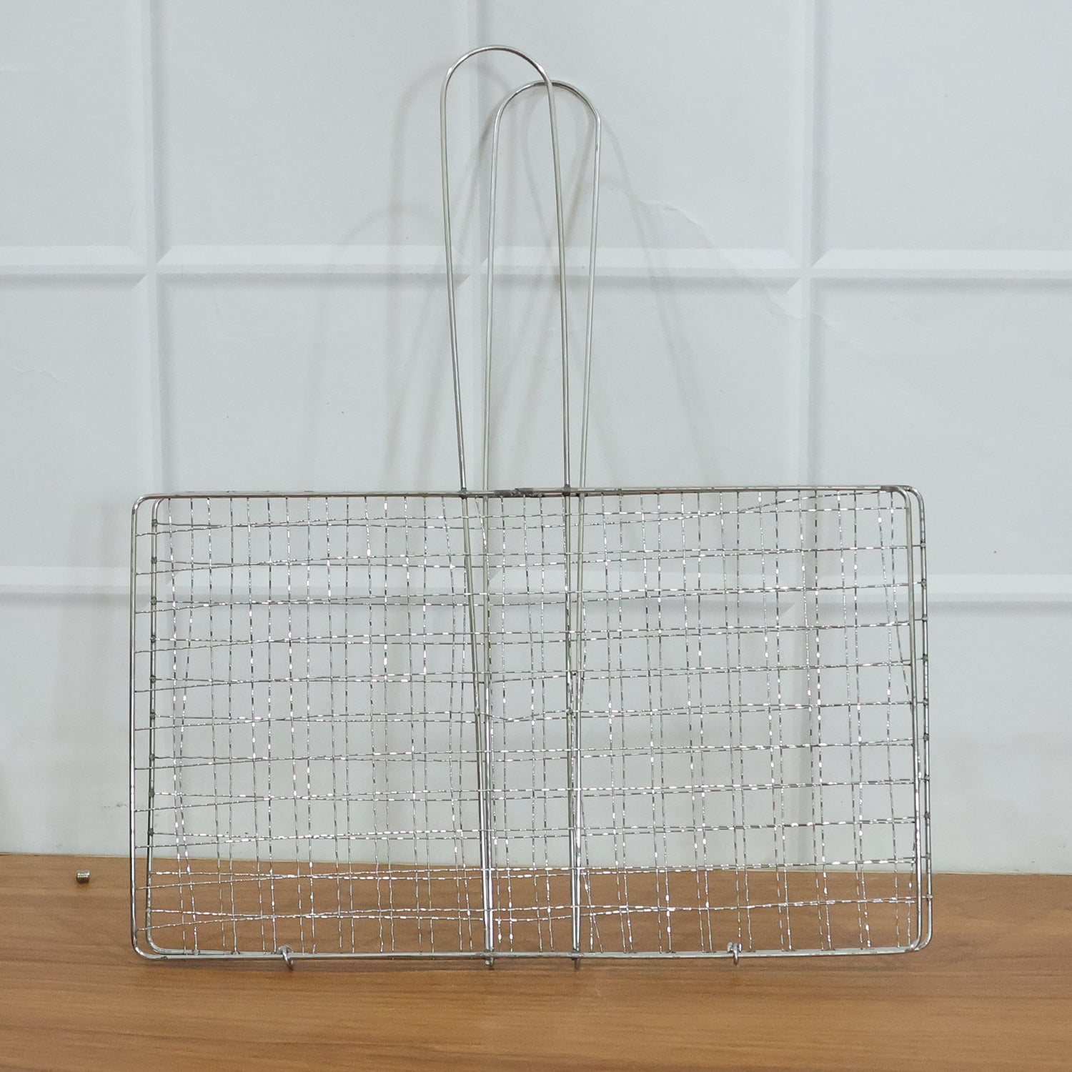 Wukusy heavy-duty stainless steel barbecue grill basket for grilling vegetables, meats, and seafood on outdoor grills.