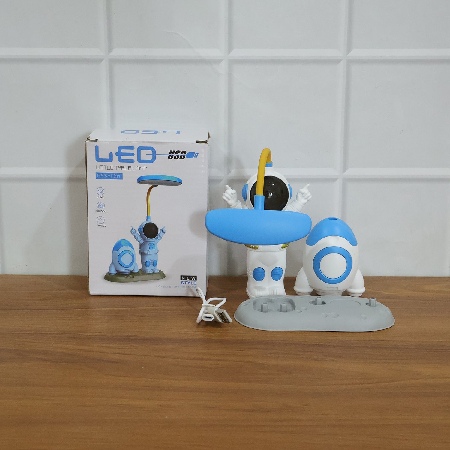 Kids astronaut LED study table lamp by Wukusy with built-in pencil sharpener, featuring a playful astronaut design for children's study space.