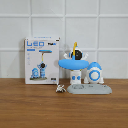 Kids astronaut LED study table lamp by Wukusy with built-in pencil sharpener, featuring a playful astronaut design for children's study space.