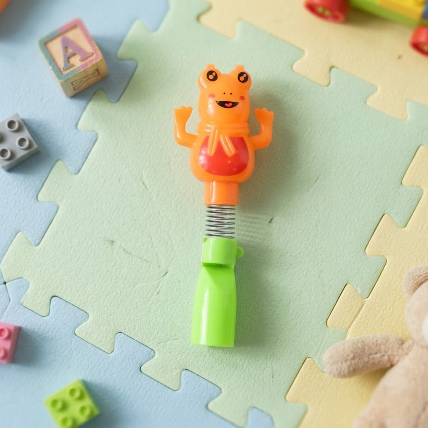 Kids cartoon spring frog toy with toothbrush set, 2-piece Wukusy kids' dental playset featuring colorful frog characters.