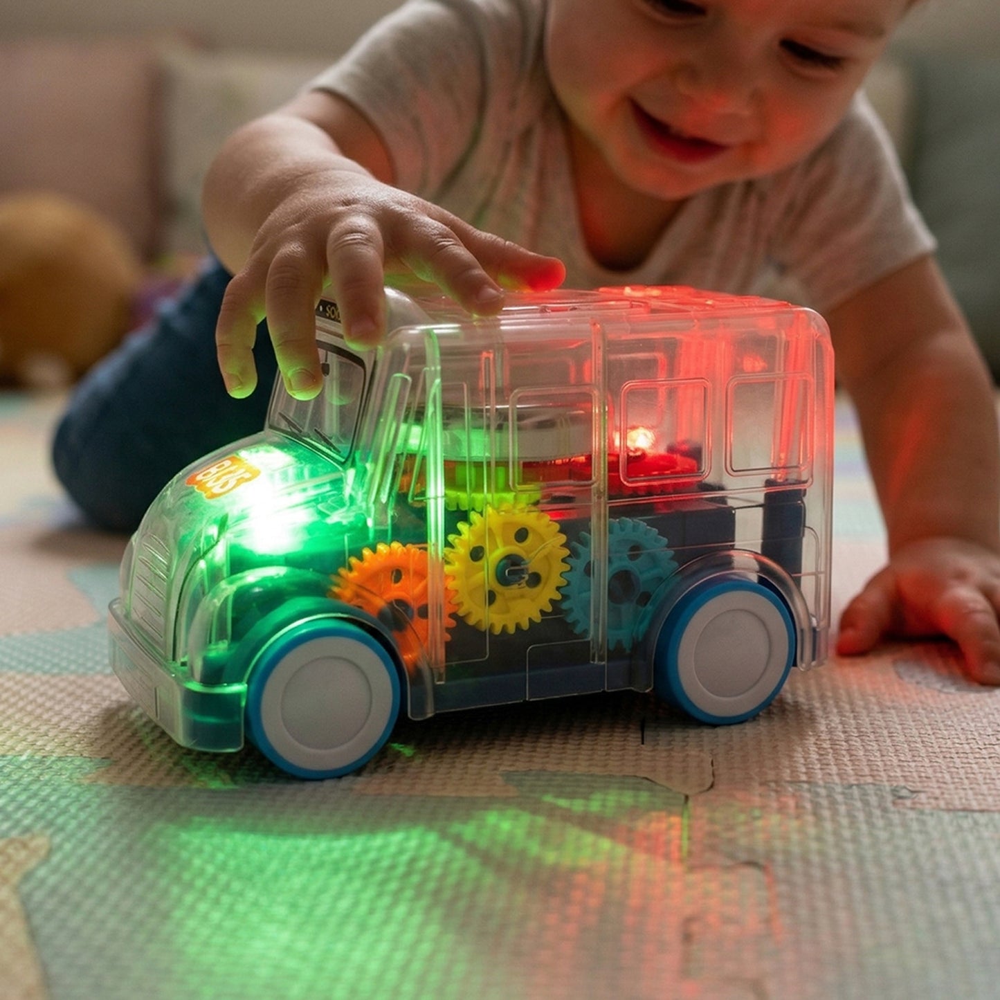 Kids transparent musical light-up school bus toy by Wukusy with colorful LED lights and musical features for children.
