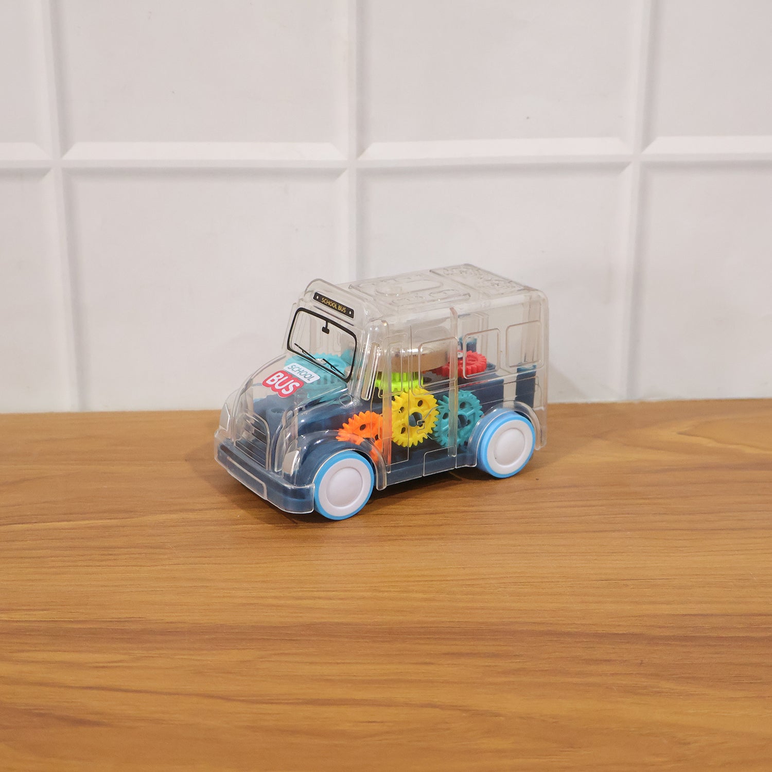 Kids transparent musical light-up school bus toy by Wukusy, featuring colorful lights and detailed bus design for children.
